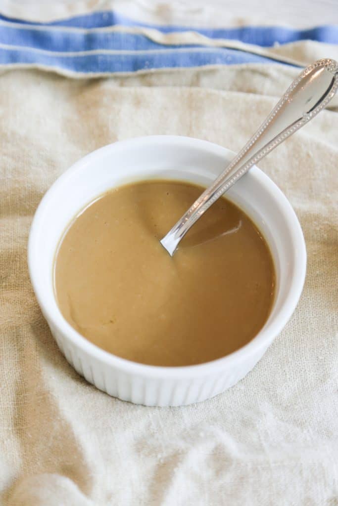 dijon mustard sauce in a white bowl with a spoon