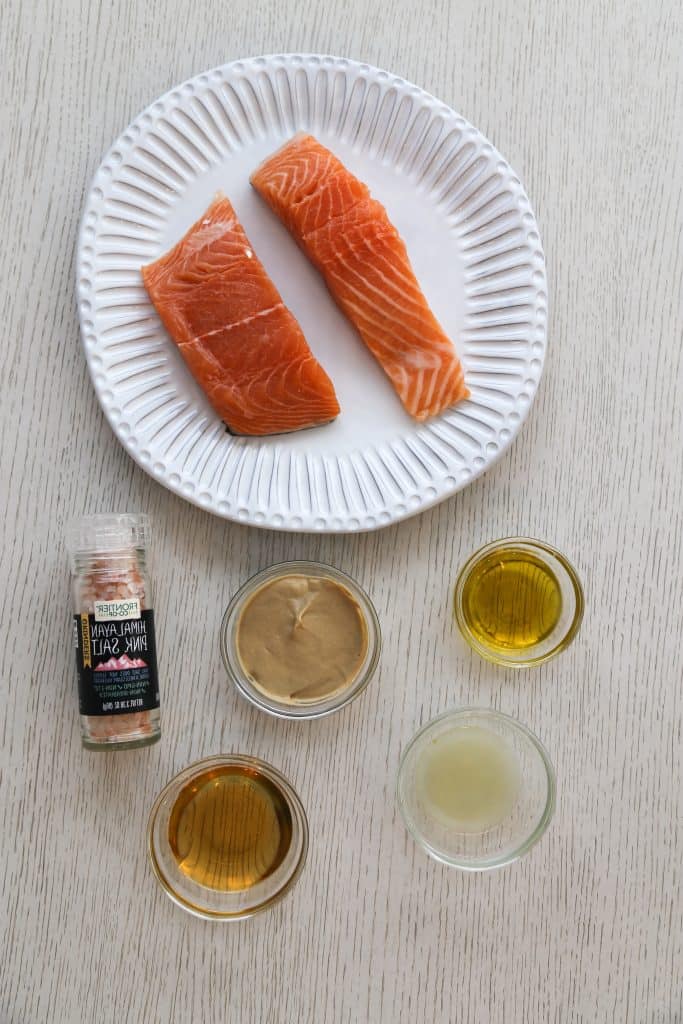 air fryer salmon ingredients with dijon mustard sauce including salmon, salt, dijon mustard, lemon juice and olive oil