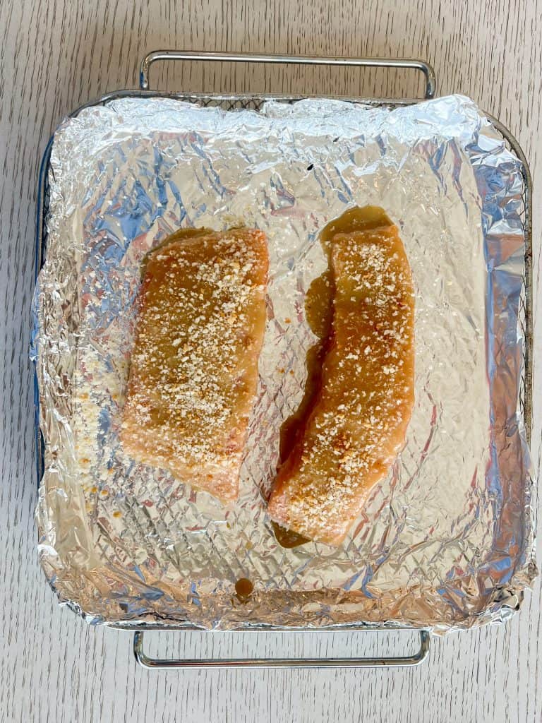 process shot showing uncooked air fryer salmon in an air fryer basket
