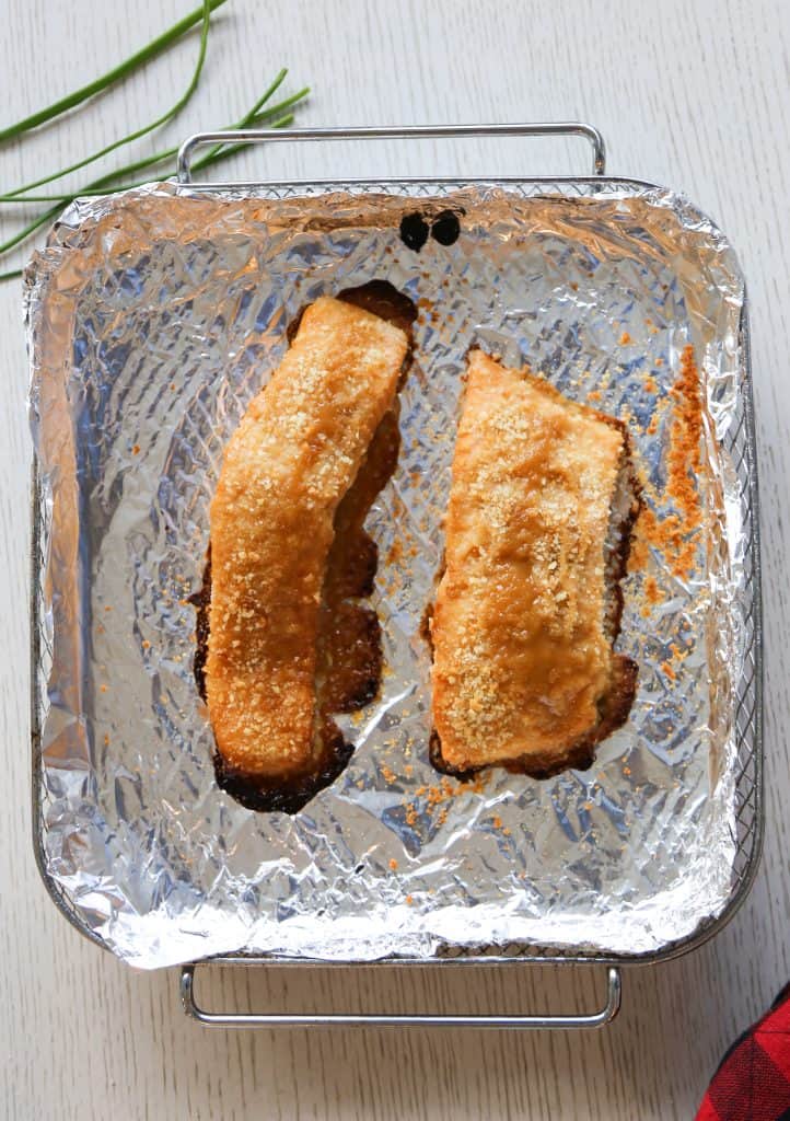 air fryer salmon with dijon mustard sauce in an air fryer basket after cooking
