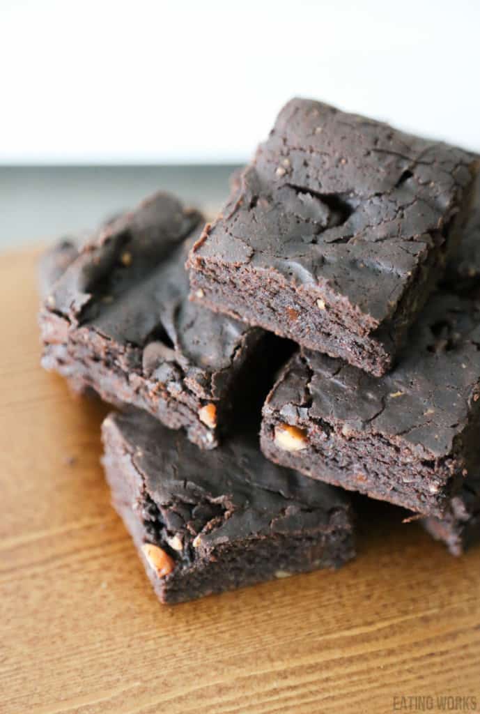 vegan avocado brownies stacked on a cutting board view from above