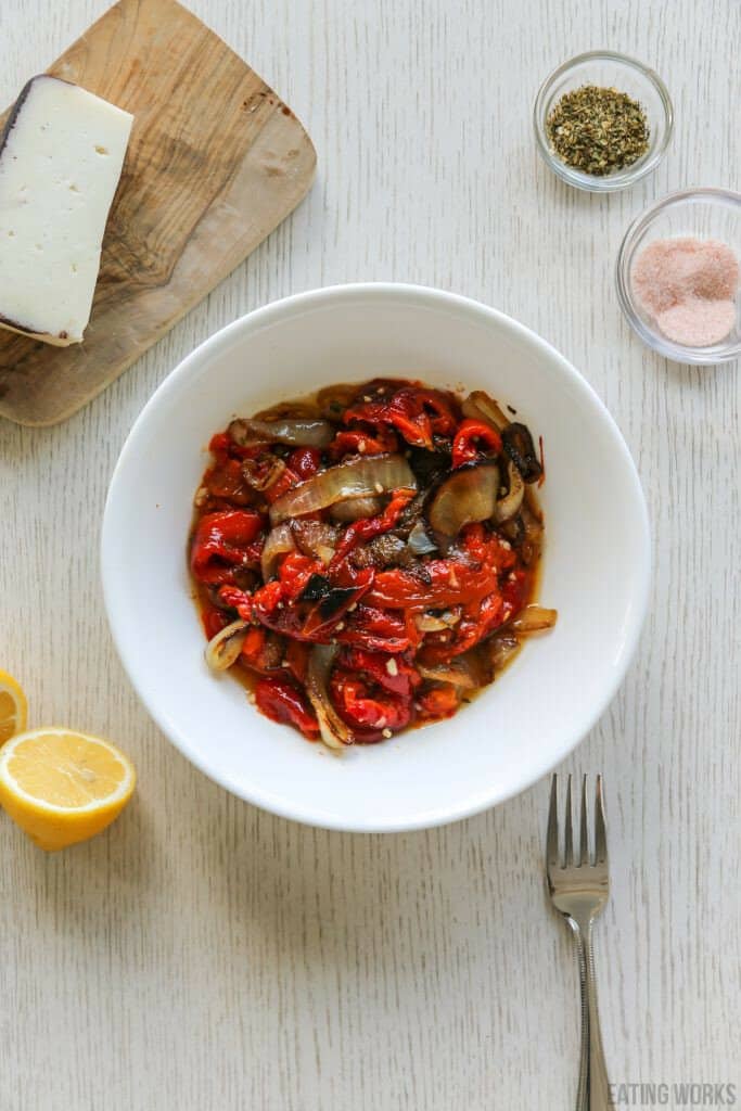 roasted peppers and onions in a white bowl 