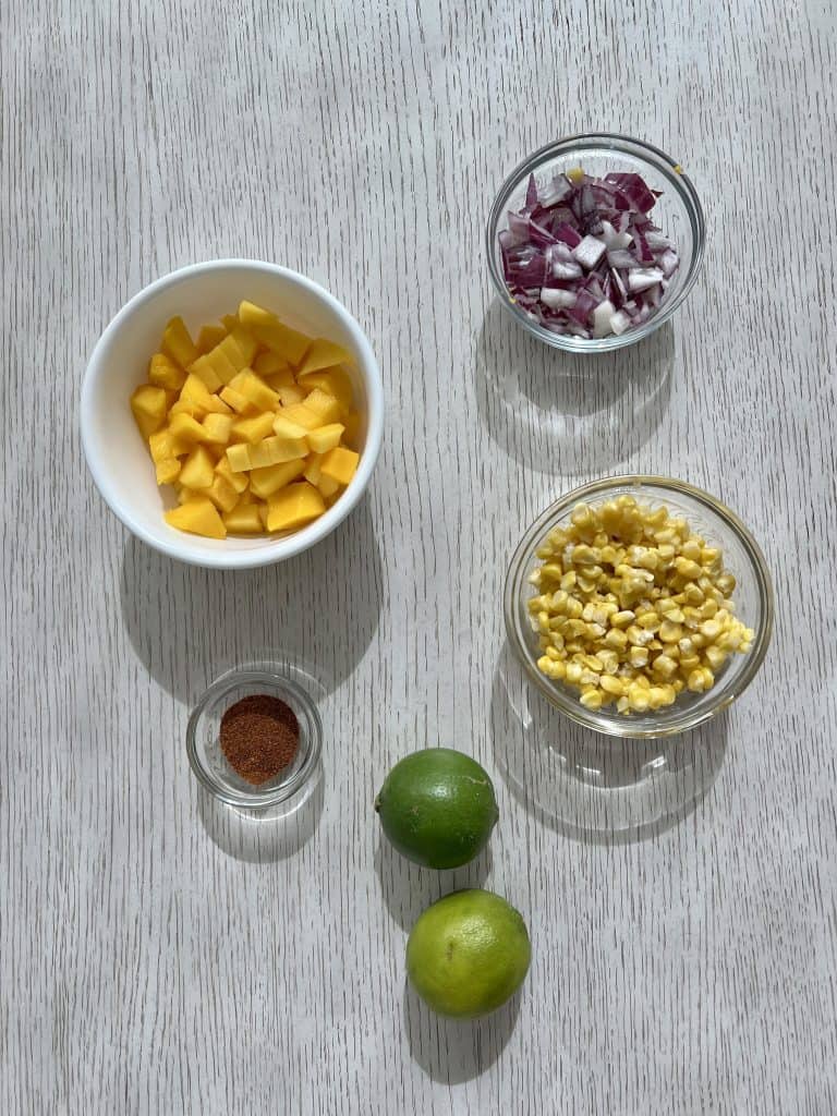 ingredients for mango corn salsa mango red onion, corn cayenne pepper  and lime 