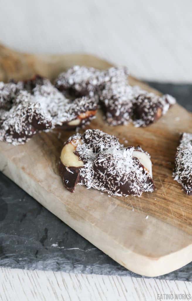 chocolate covered brazil nuts on a cutting board
