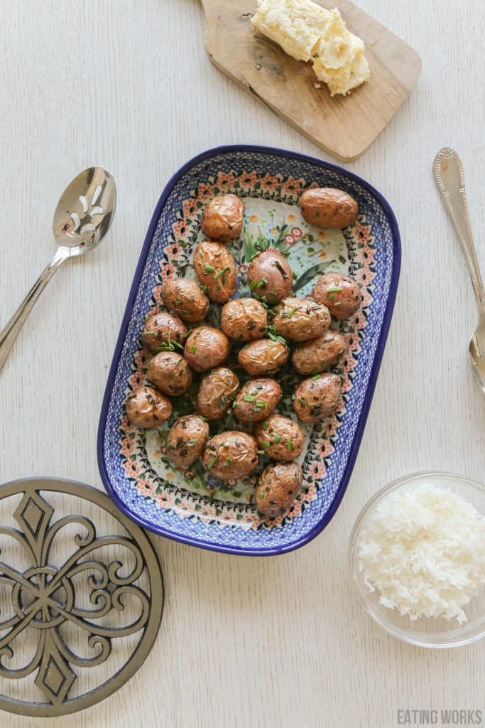 Air fryer red skinned potatoes in a dish with rice garlic butter and a spoon