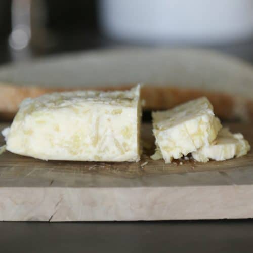 roasted garlic compound butter sliced on a cutting board