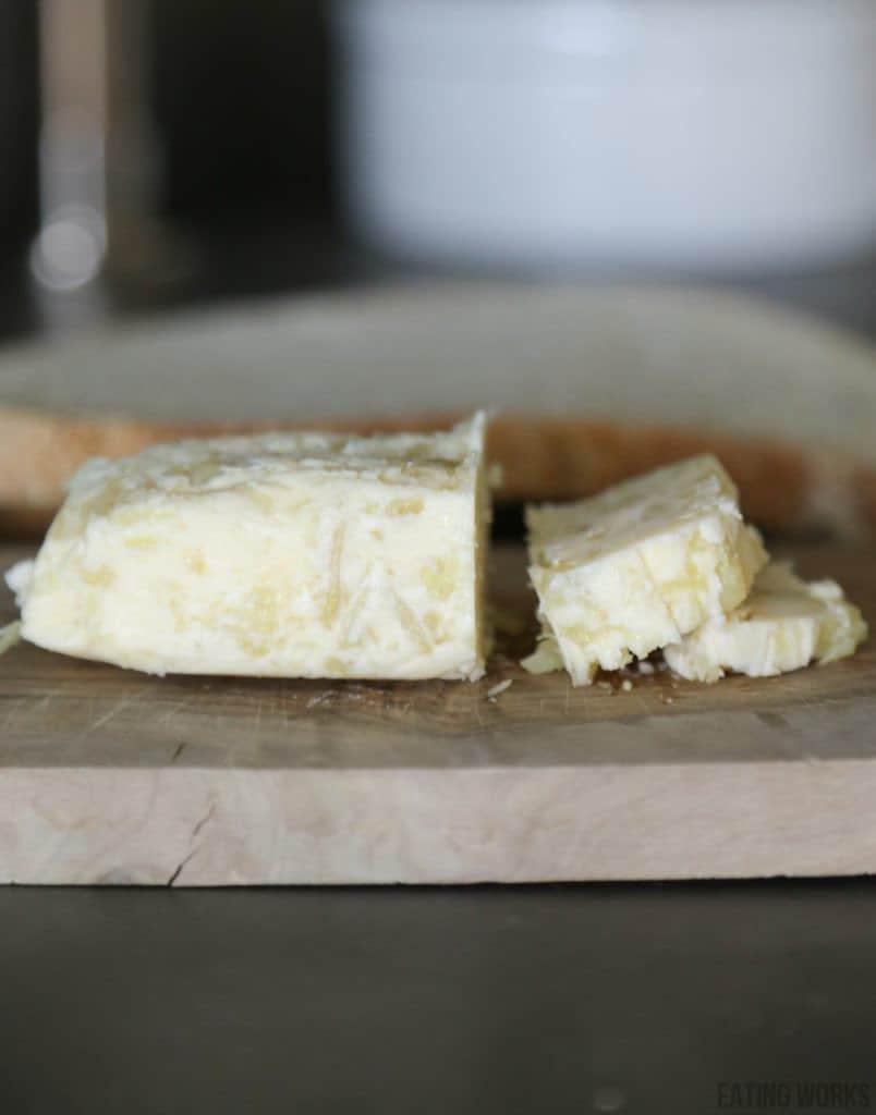 roasted garlic compound butter sliced on a cutting board