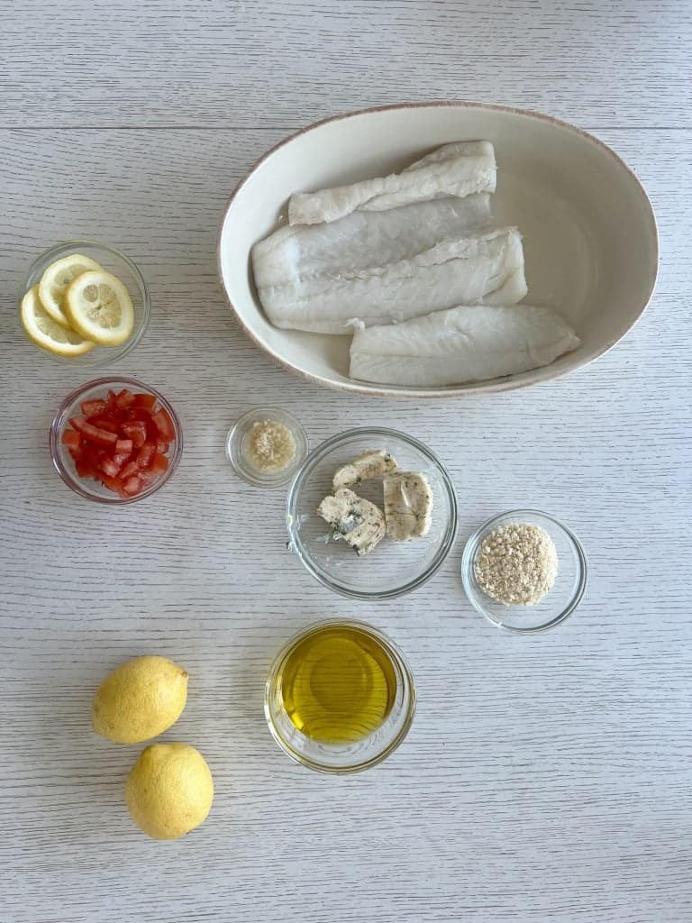 ingredients for greek cod recipe, cod fish fillet, tomato, lemon, greek butter , gluten free panko breadcrumbs, garlic