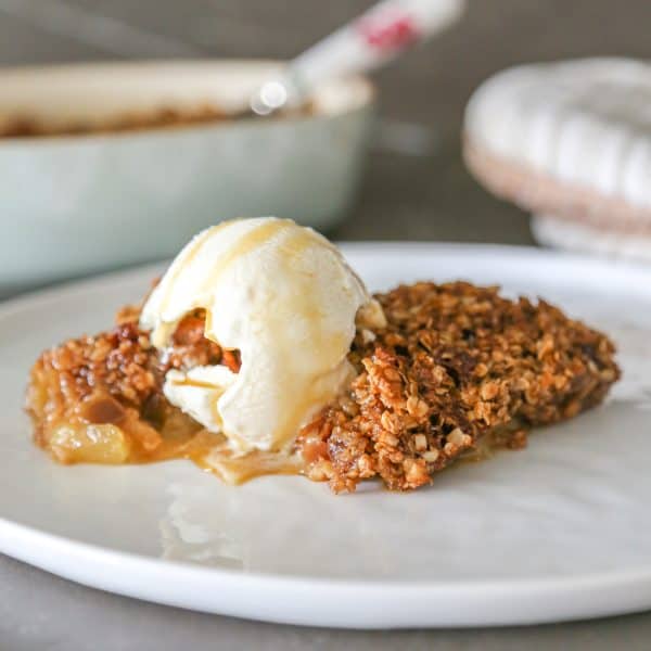 gluten free apple crumble without flour on a plate with a scoop of ice cream