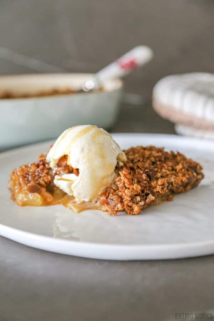 gluten free apple crumble without flour on a plate with a scoop of ice cream