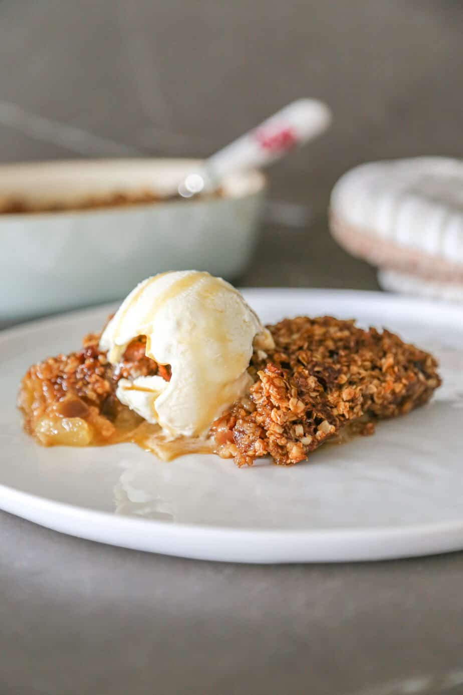 Gluten free apple crumble without flour on a plate with a scoop of ice cream.