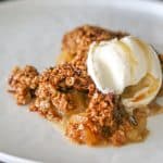 gluten free apple crumble without flour on a plate with a scoop of ice cream