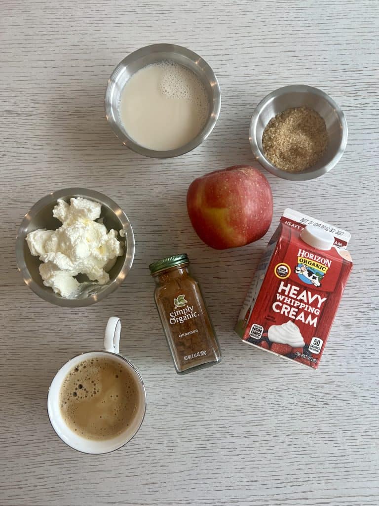 ingredients for starbucks apple crisp macchiato recipe oat milk, sugar, whipped cream, fuji apples, cinnamon and espresso