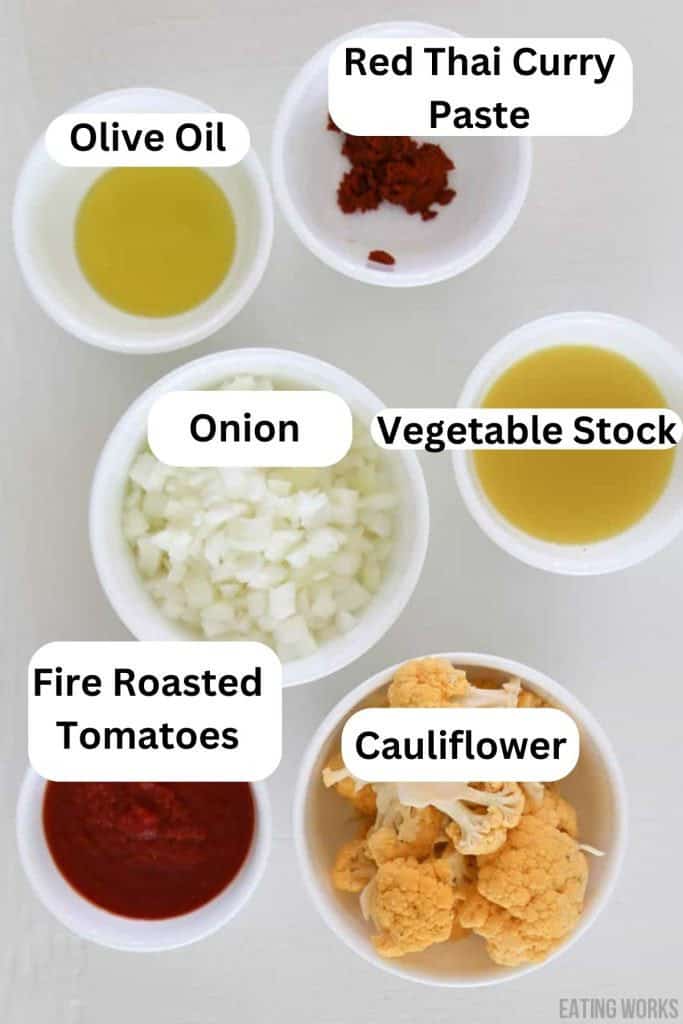 ingredient photo for curried cauliflower soup showing onion, fire roasted tomatoes, cauliflower, vegetable stock, red thai curry paste.