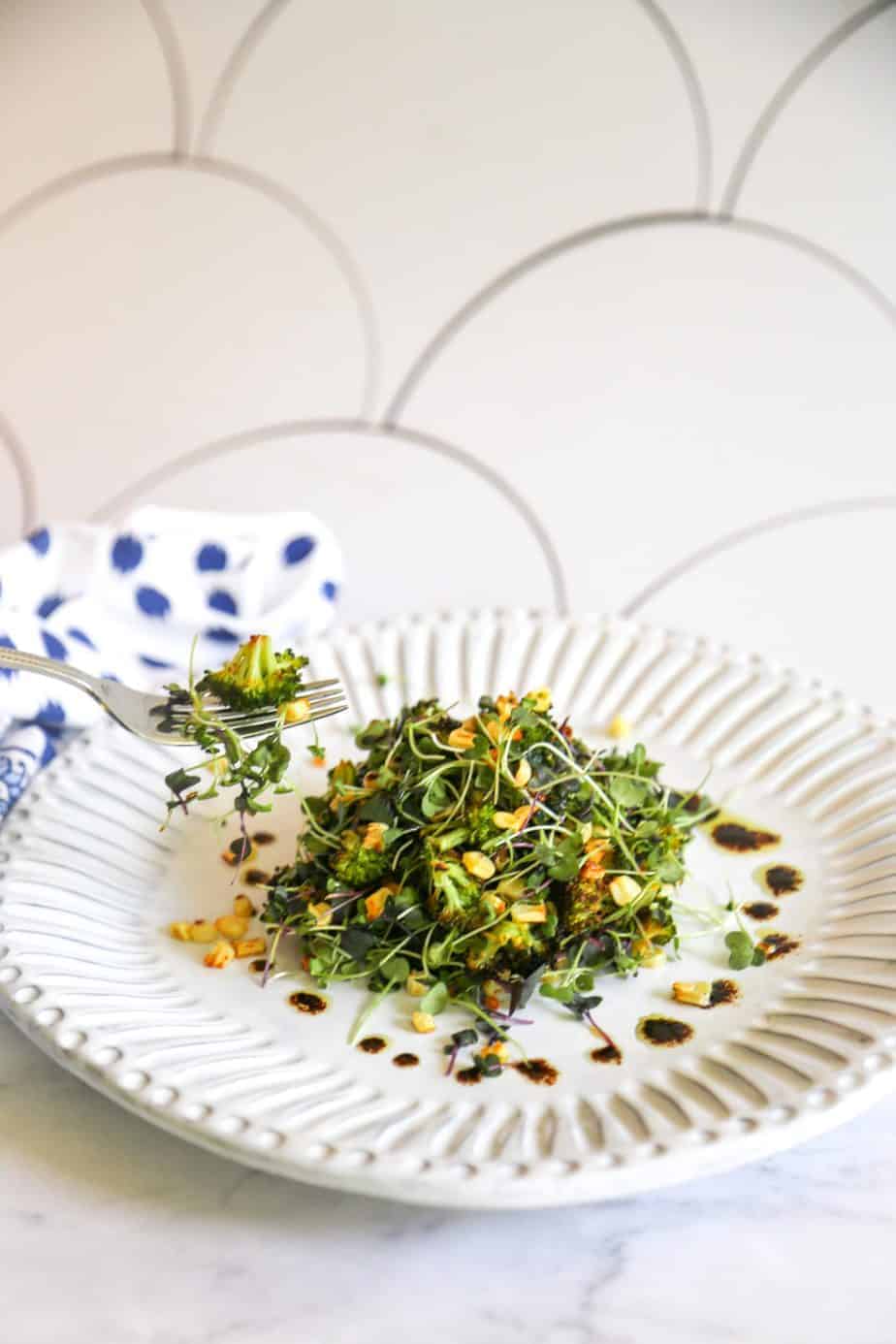 Roasted broccoli salad with corn mixed microgreens and balsamic vinaigrette.