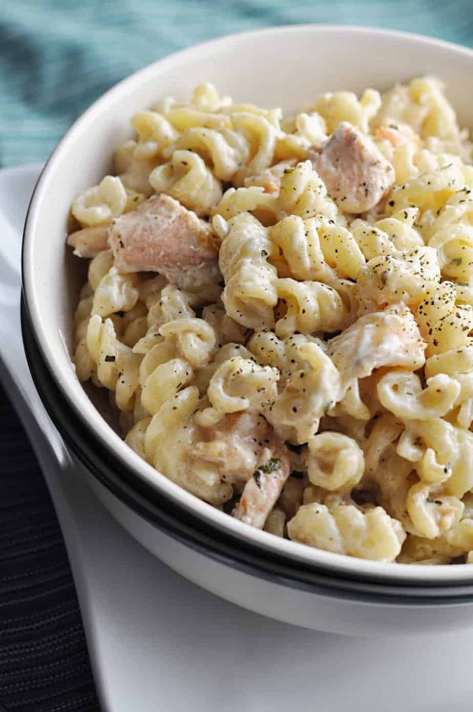 Creamy salmon and shrimp with pasta recipe in bowl.