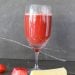 Watermelon and pineapple juice in a wine glass with chunks of watermelon and pineapple